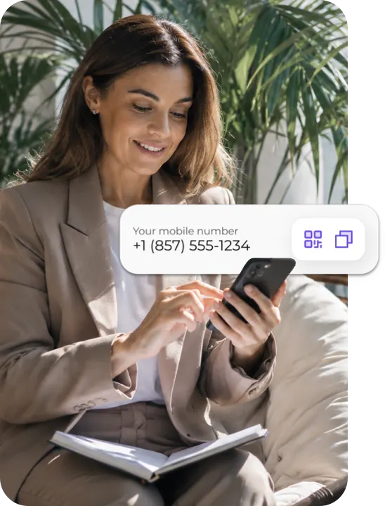 Woman smiling at her phone showing her U.S. mobile number